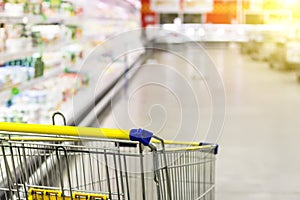 Cart at the grocery store. Abstract blurred photo of store with trolley in department store bokeh background.