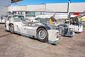 Cart tow tracktor ready to pushing the airplane back on the front landing gear of the chassis.