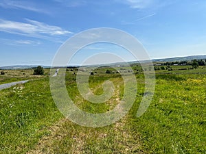 Cart track crossing the moor top, with roads and trees in, Clapham, Yorkshire, UK photo