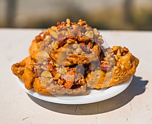 Cartellate Pugliesei italian traditional food from Puglia region named crispy puff pastry with honey and almond