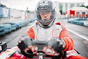 Carting race, go kart driver in helmet, front view