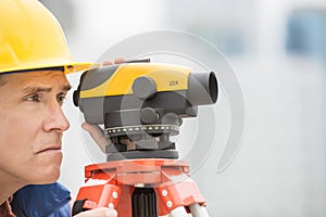 Cartographer Measuring Distances Through Theodolite photo