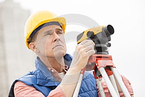 Cartographer With Theodolite At Construction Site photo