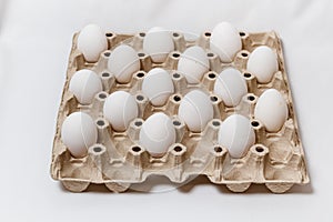 carton box with distanced white eggs on white background. concept of quarantine rules