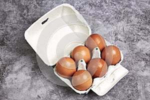 Carton box with half a dozen fresh brown eggs. Healthy food