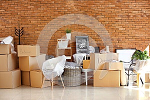 Carton boxes and interior items in room. Moving house concept