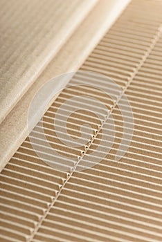 Carton or cardboard packing material. Texture of corrugated paper sheets made from cellulose. Supplies for creating boxes.