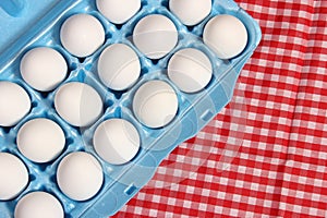 Carton of Eggs on Rustic Table With Checkered Table Cloth