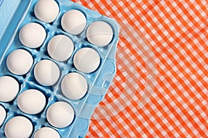 Carton of Eggs on Rustic Table With Checkered Table Cloth