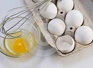 Carton of eggs with whisk photo