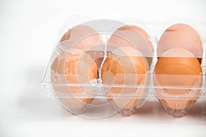 Carton of fresh free range eggs on a white background.