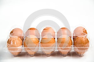 Carton of fresh free range eggs on a white background.