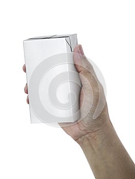 Carton of milk or juice package in hand isolated on white background