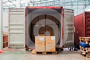 The cartons with loading out of container photo