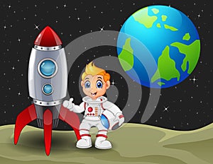 Cartoon astronaut boy holding a helmet and rocket space ship on the moon with planet earth in the background