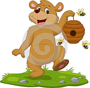 Cartoon bear holding beehive on the grass