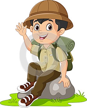 Cartoon boy scout sit on the rock waving hand