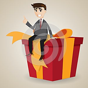 Cartoon businessman sitting on big gift box