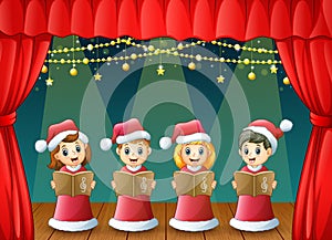 Cartoon children in red santa costume singing christmas carols on the stage