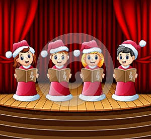 Cartoon children in red santa costume singing christmas carols on the stage