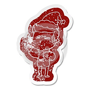 cartoon distressed sticker of a man sweating wearing santa hat