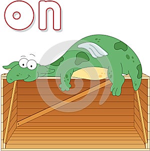 Cartoon dragon lies on a box. English grammar in pictures photo