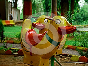 Cartoon duck chair for kids playing presented on green park background