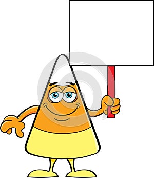 Cartoon happy candy corn holding a sign.