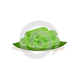 Flat vector icon of kuih ketayap on green leaf. Traditional Malaysian dessert. Sweet food. Asian cuisine