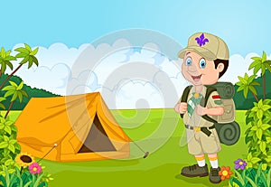 Cartoon little boy scout with tent photo
