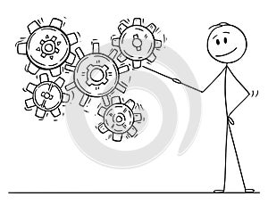 Cartoon of Man or Businessman Pointing at Working Cogwheels or Cog or Gear Wheels