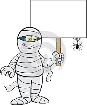 Cartoon mummy holding a sign with a spider.