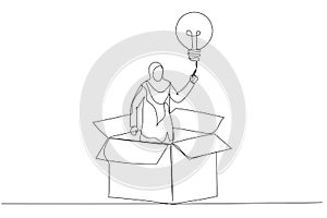 Cartoon of muslim businesswoman get out of paper box with new illumination lightbulb idea. Think outside the box. Continuous line