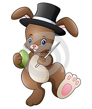 Cartoon rabbit magician wearing a hat with holding magic wand and egg