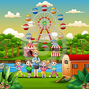 Cartoon of school children and a teacher with amusement park background