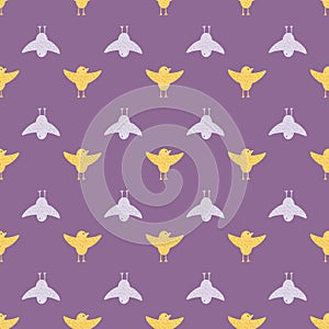 Cartoon seamless pattern with yellow and blue colored flying birds ornament. Purple background