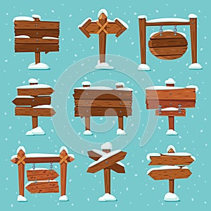 Cartoon snowed signpost. Christmas wooden signpost with snowcap. Arrows on snow and direction signs with icicles on top vector set