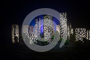 Cartoon style city buildings. Realistic city building miniatures with lights. background