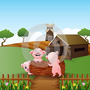 Cartoon three little pigs play in the log with farm background