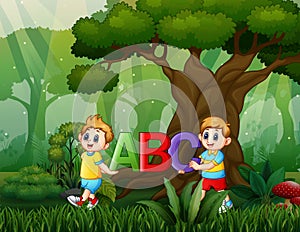 Cartoon two boys holding ABC text on the nature