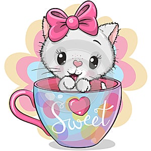 Cartoon white kitten with a bow is sitting in a Cup