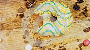 Cartoons transformed into Donut has a mouth-shaped bite. Yellow donuts decorated with blue icing. Donuts are on a piece