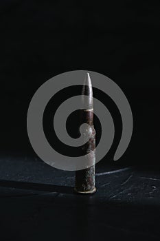 Cartridge on a dark background close-up. The concept of modern armaments and war in Ukraine