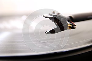 Cartridge of a modern high quality turntable record player about to be lowered onto a vinyl analogue music LP