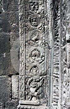 Carved basreliefs with a figure of a dinosaur on the temple