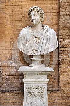 Carved Bust In Front of Brick Wall