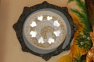 Carved circle window in brahma vihara arama buddhist temple, bali, indonesia. Stone carved of circular window in a