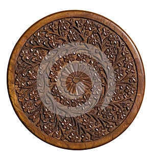 Carved circular wood panel with floral design