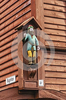 Carved figure of a viking on the side of a wooden building, Bryggen, Bergen, Norway