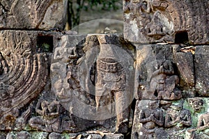 Carved figures bas-relief of Angkor Wat complex temple, Siem Reap, Cambodia. Stone ruin puzzle with buddha